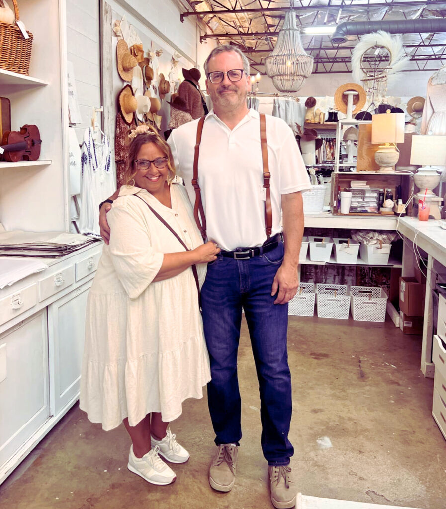 Photograph of Polly McCormick, and her husband, Mick behind the counter at Georgie Emerson Vintage.