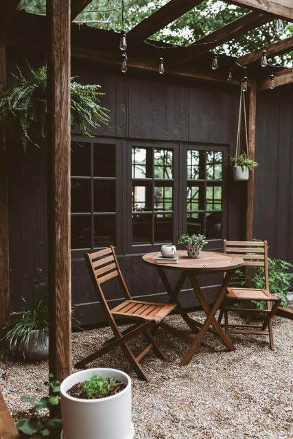 Outdoor shed with a wood bistro table.