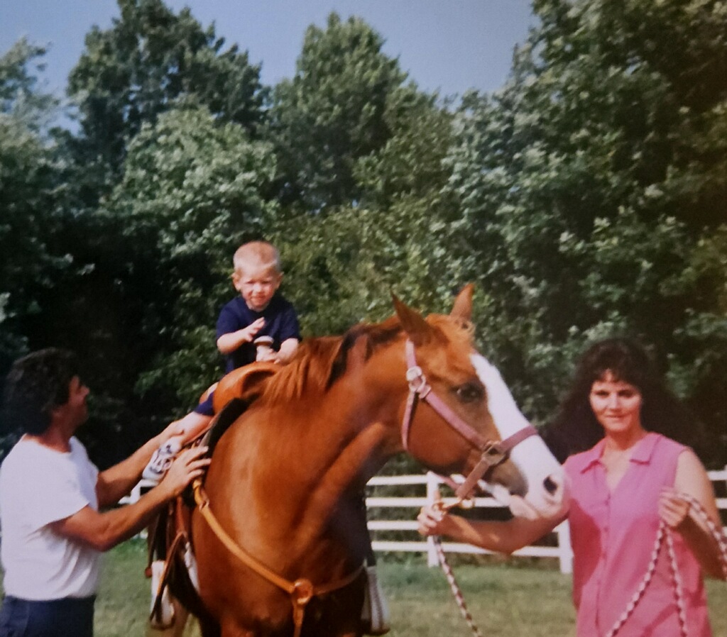 Kelly Swingle guiding a horse during a horse camp on her horse ranch.